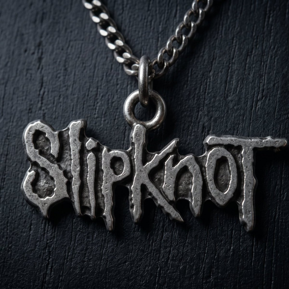 We Rock Slipknot logo pendant necklace in a distressed silver metal finish on a dark textured background