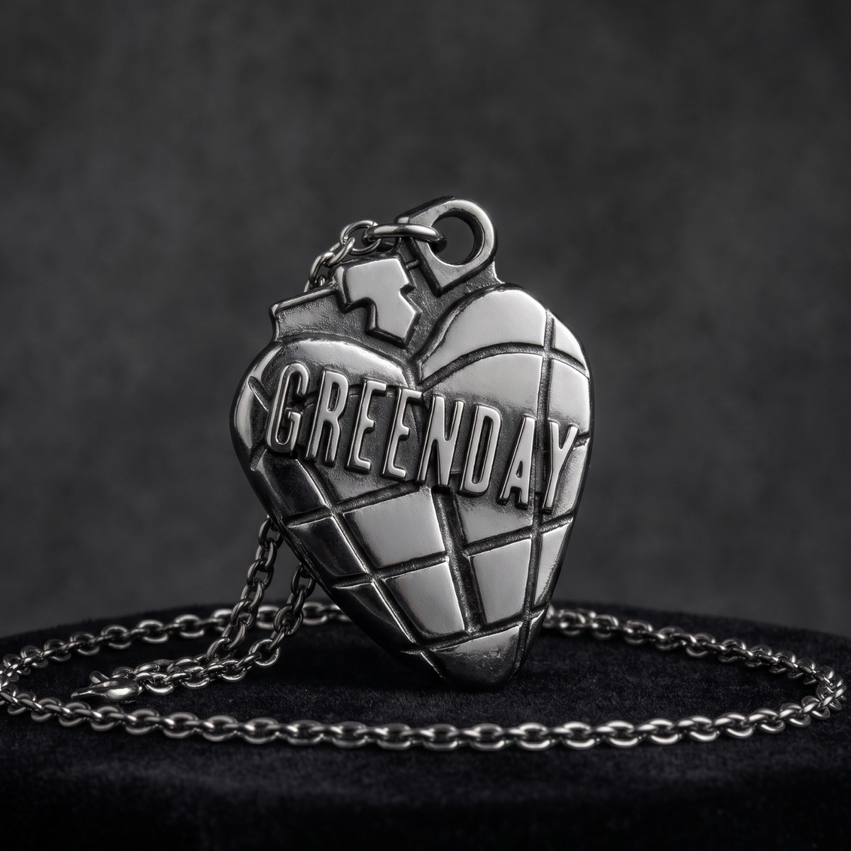 We Rock Green Day heart grenade pendant necklace in polished silver metal on a black velvet display stand