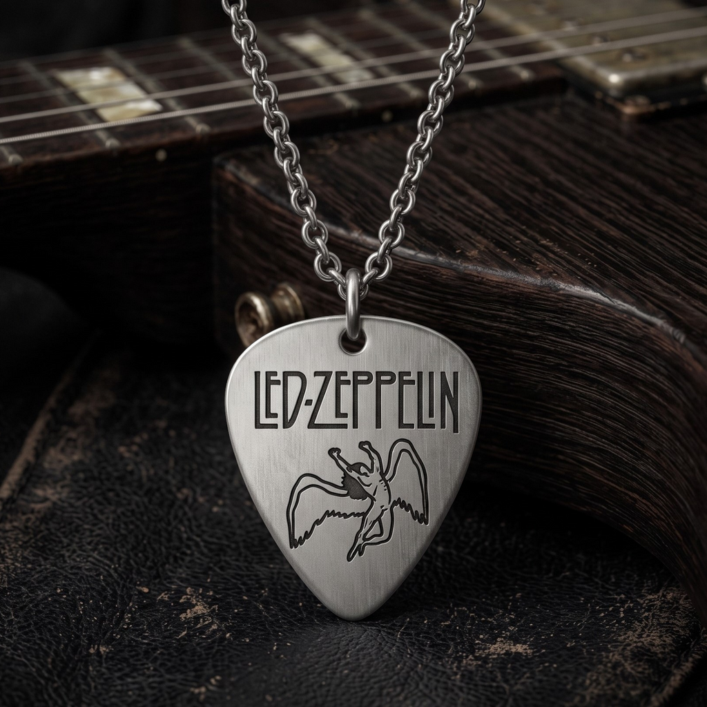 We Rock Led Zeppelin guitar pick necklace in brushed silver hanging over a dark wooden electric guitar body
