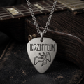 We Rock Led Zeppelin guitar pick necklace in brushed silver hanging over a dark wooden electric guitar body