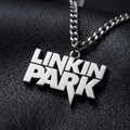 We Rock silver-tone Linkin Park logo pendant necklace on a black textured leather background