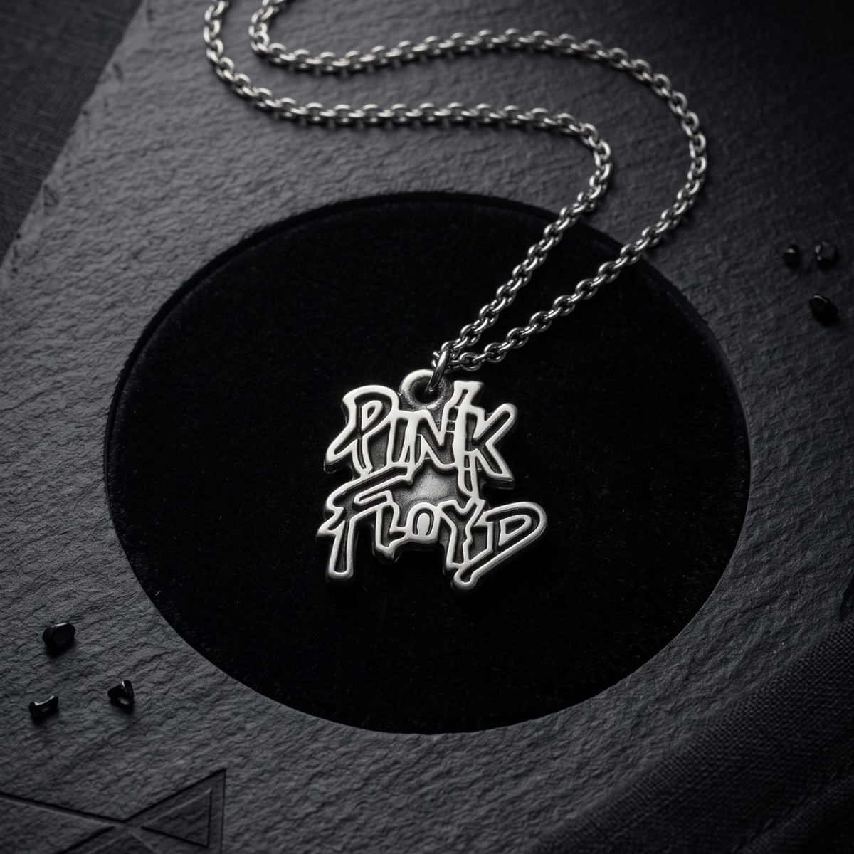 We Rock silver-toned Pink Floyd logo pendant necklace on a black textured display background